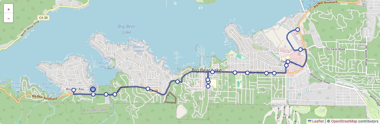 An interactive map of the Big Bear Blue Line, tracing the route along the south shore of Big Bear Lake from Boulder Bay to the Village, with stops marked and a live bus icon near Boulder Bay.