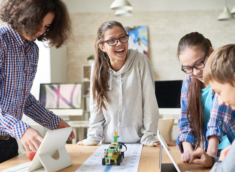 Smiling children are working on computers.